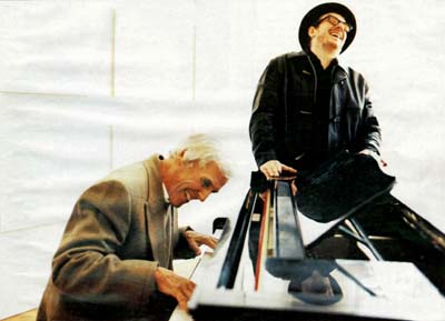 Elivs Costello Sitting on Piano as Burt Bacharach plays