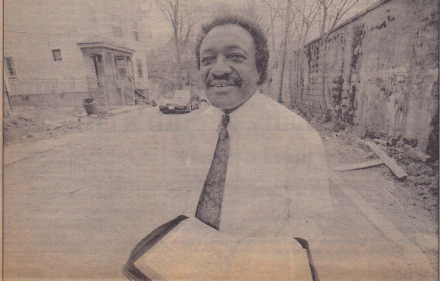Photo of Lee Mitchell On the street where he lived, Bible in hand take by Michael Fein